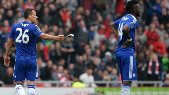 John Terry of Chelsea throws his captain's armband as he walks off the pitch.
