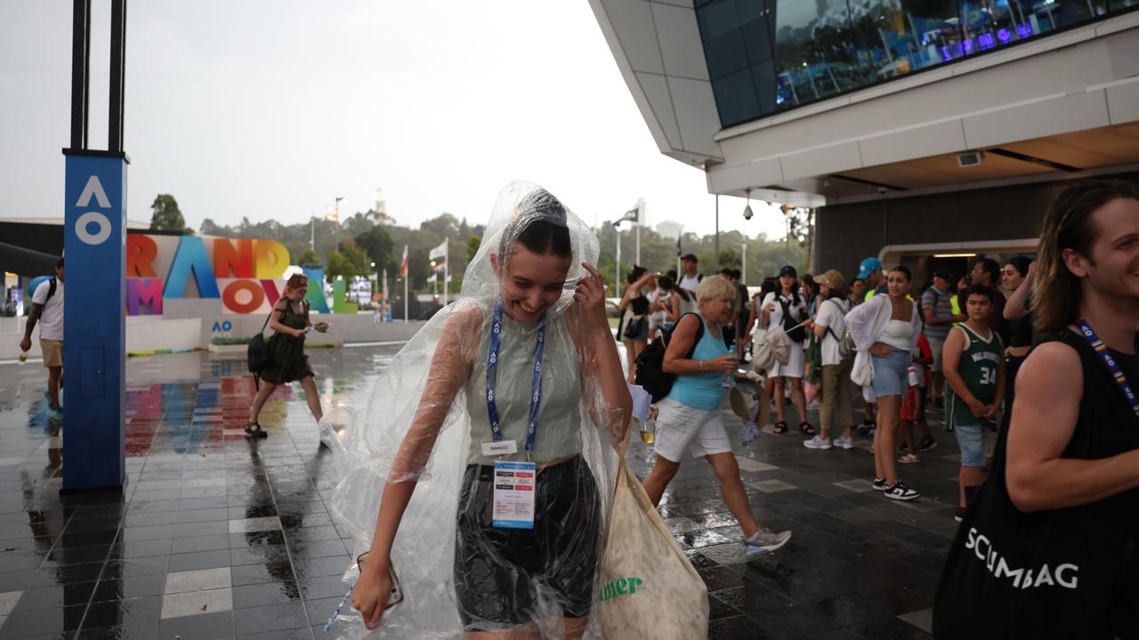 Spectators at Melbourne Park rush to shelter from the rain. Picture: Kim Landy/Getty Images