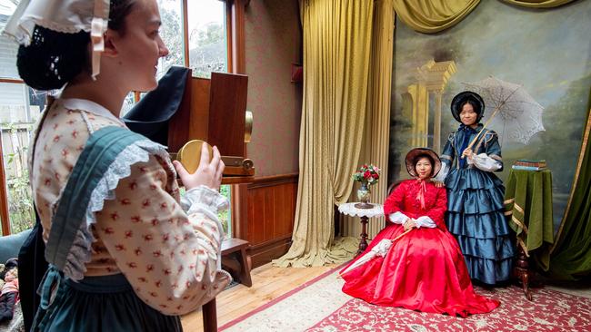 Chinese tourists, Cheng Qianying and Zhang Lichun have their photo taken in period dress at Sovereign Hill.