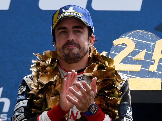 Fernando Alonso on the podium after winning the 87th edition of the 24 Hours Le Mans endurance race. (Photo by Jean-Francois MONIER / AFP)