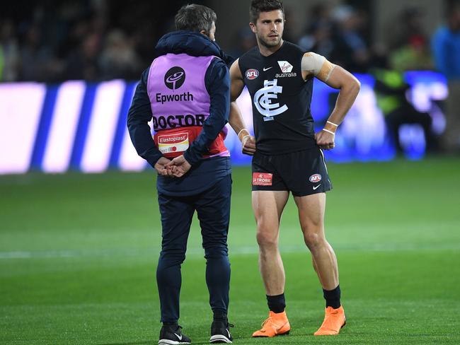 Marc Murphy speaks to the doctor after hurting himself in the pre-match warm-up.