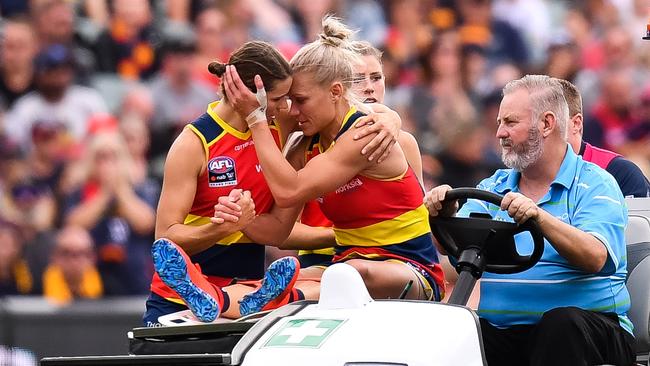 Erin Phillips is consoled by her Adelaide co-captain Chelsea Randall as she is stretchered from Adelaide Oval following her knee injury in the AFLW grand final. Picture: DANIEL KALISZ (GETTY IMAGES).