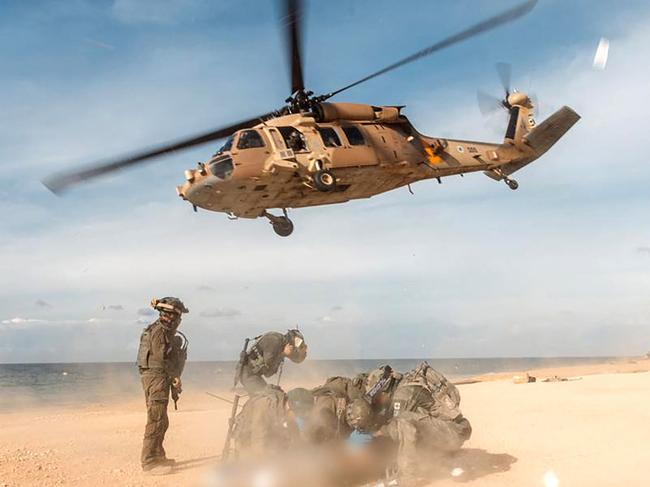 Israeli Air Force preparing an Israeli soldier for evacuation at a beach in the Gaza Strip. Picture: AFP