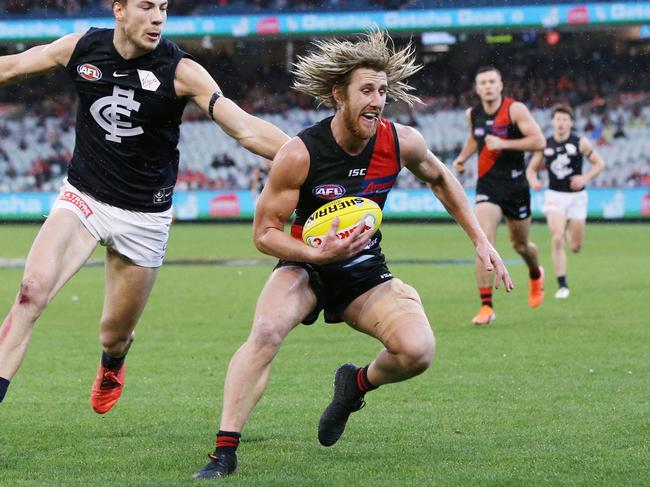 MELBOURNE, AUSTRALIA - JUNE 02: Dyson Heppell of the Bombers evades Harry McKay of the Blues during the round 11 AFL match between the Essendon Bombers and the Carlton Blues at Melbourne Cricket Ground on June 02, 2019 in Melbourne, Australia. (Photo by Michael Dodge/AFL Photos/Getty Images)