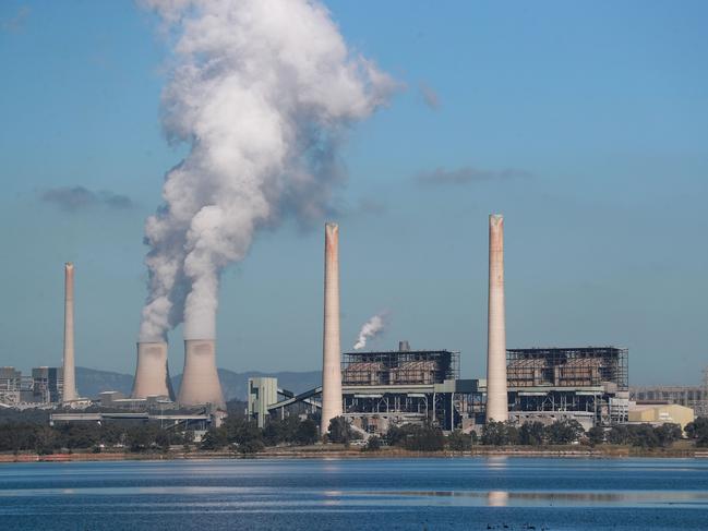 MUSWELLBROOK, AUSTRALIA - APRIL 27: Liddell Power Station stands next to Lake Liddell as chimneys at the Bayswater Power Station seen emit water vapour on April 27, 2023 in Muswellbrook, Australia. Liddell Power Station, one of Australia's oldest coal-fired power plants, will shut down on Friday, 28 April, after 52 years in operation. The AGL-owned facility opened in 1971 and was once the most powerful generating station in Australia. With Australia making the transition from coal power to renewables, the site will be transformed into a new low-carbon industrial energy hub. Demolition of the plant will begin next year, with more than 90 per cent of the materials to be recycled, AGL says. The closure of Liddell Power Station will stop 8 million tonnes of Carbon dioxide being released into the atmosphere every year, media reported. (Photo by Roni Bintang/Getty Images)