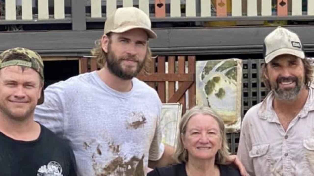 Pat Rafter (right) and Luke and Liam Hemsworth have been helping the clean up effort in Lismore.