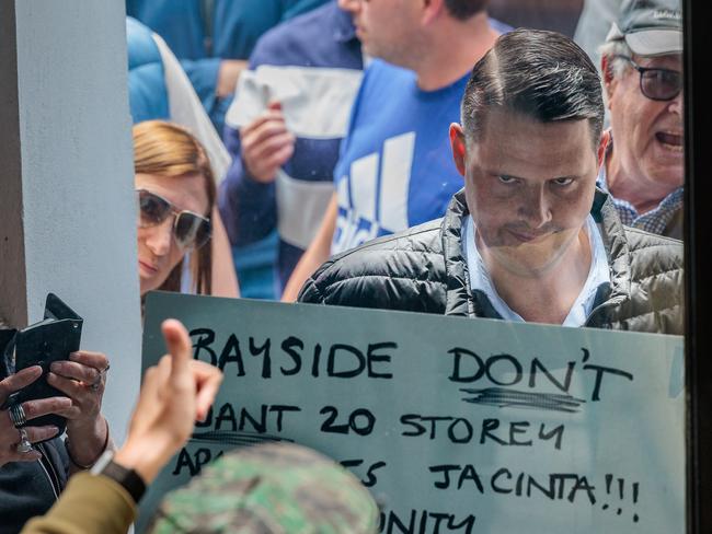 Local protestors and Member for Brighton James Newbury chant after the Premier’s announcement. Picture: NewsWire / Nadir Kinani