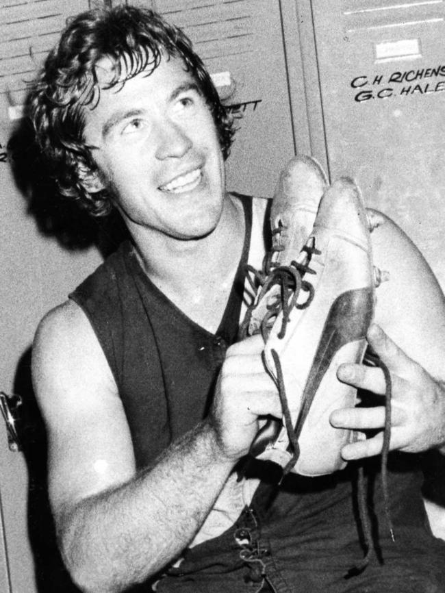 Fred Phillis holds his yellow boots after kicking 18 goals against Central District in 1975.