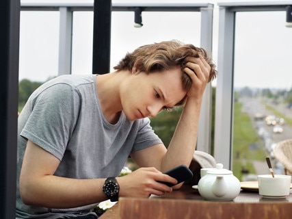 Lifestyle portrait of a young man texting sms