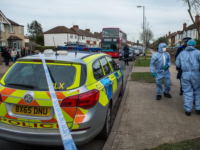 Two police forensics officers prepare to enter a police tent outside the home of Russian exile Nikolai Glushkov who was found dead at his home in New Molden. Picture: Getty