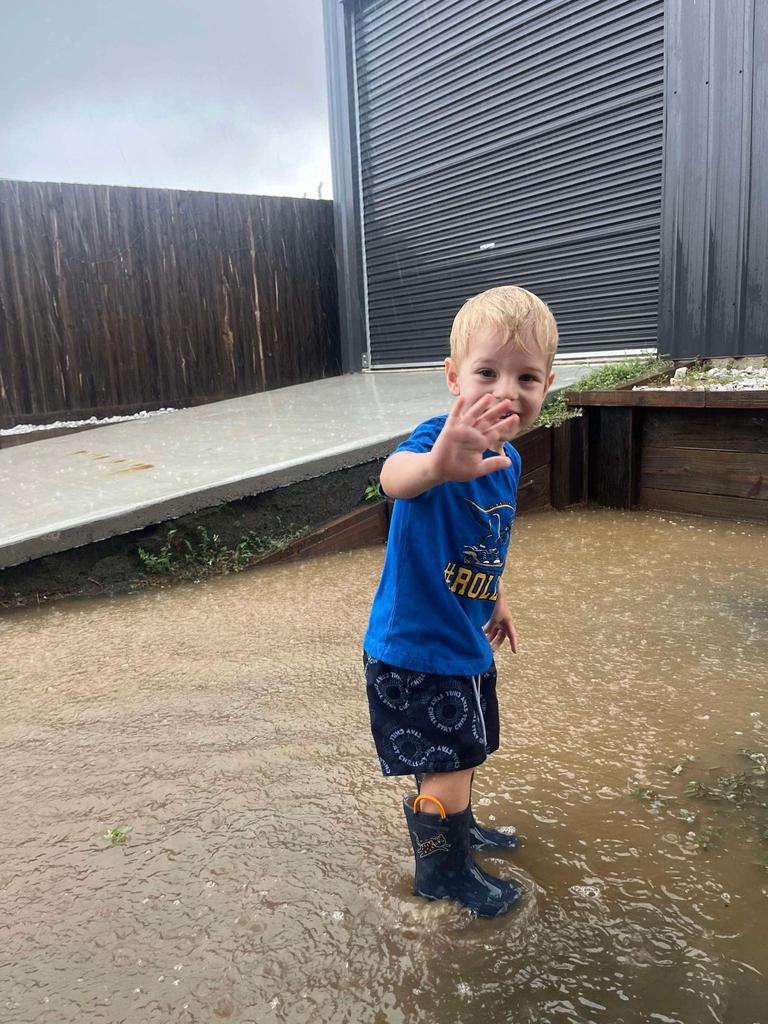 Hervey Bay local Zander braves the rain brought by ex-Tropical Cyclone Alfred. Photo: Davina Ebenezer