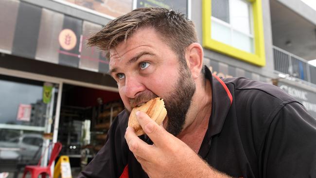 Shaun Pyne tucks into a hearty pie at Marcoola Bakery.