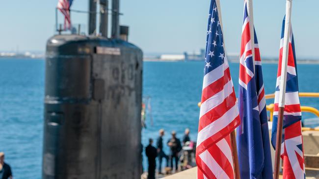 National flags of the USA, Australia and Great Britain are seen in front of the USS Asheville, a Los Angeles-class nuclear powered fast attack submarine, at HMAS Stirling, Western Australia on Tuesday, March 14, 2023. Picture: NCA NewsWire / pool / Richard Wainwright