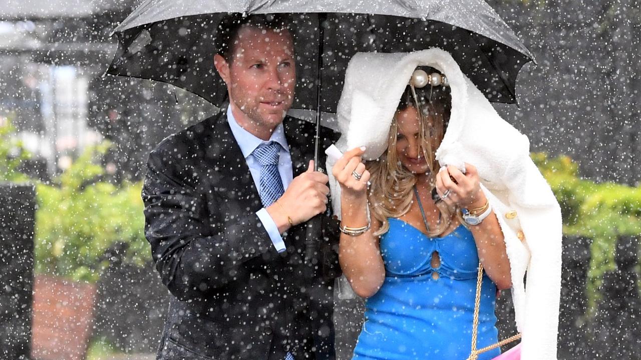 Many revellers tried to hide their makeup and hair from showers.