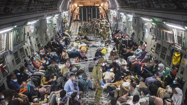 Australian citizens and visa holders evacuees travel to the Australian Defence Force's main operating base in the Middle East region, onboard a Royal Australian Air Force C-17A Globemaster III aircraft after leaving Afghanistan.