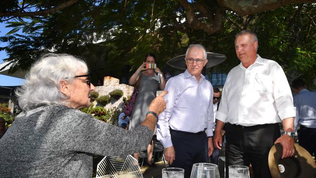 Local resident Toni Lea (left) has a run-in with Prime Minister Malcolm Turnbull and Trevor Ruthenberg in Longman on Friday.