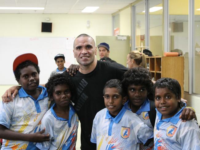 Mundine with kids at Dripstone High School. Picture: Supplied