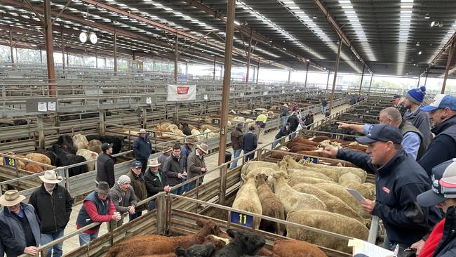 Agents take bids at the Pakenham store sale.