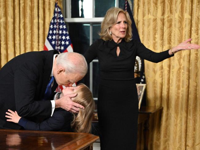 US President Joe Biden kisses his grand-son Beau Biden Jr. as First Lady Jill Biden gestures after the President delivered his farewell address to the nation from the Oval Office of the White House in Washington, DC, on January 15, 2025. (Photo by Mandel NGAN / POOL / AFP)