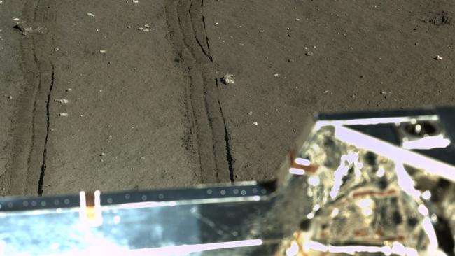 The rover’s tyre marks can be easily seen in the moon’s fine dirt. Picture: Chinese Academy of Sciences / China National Space Administration / The Science and Application Center for Moon and Deep Space Exploration