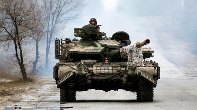 Ukrainian servicemen ride towards the front line with Russian forces in the Luhansk region of Ukraine on the second day of fighting. Picture: AFP