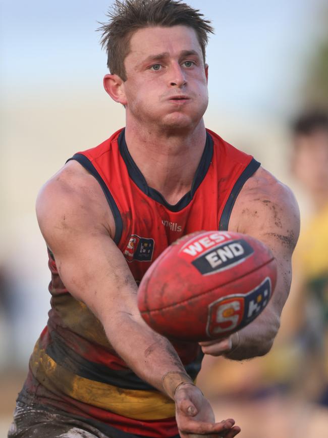 Crow Matt Crouch dishes out one of his 25 handballs against the Eagles at Woodville Oval on Sunday. Picture: SANFL Image / Cory Sutton