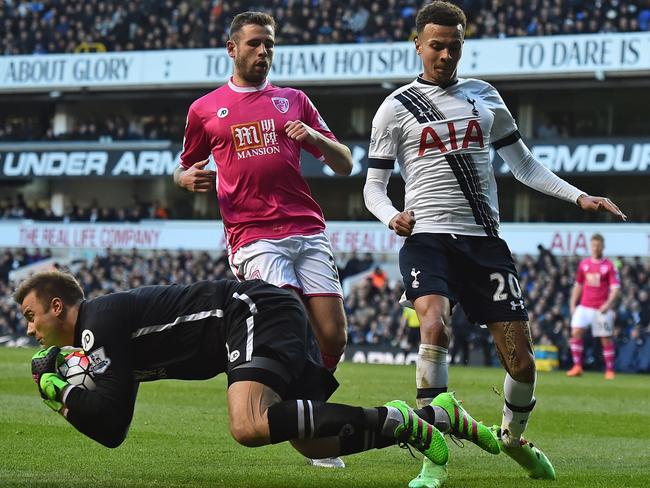 Bournemouth's Artur Boruc grabs the ball as Tottenham Hotspur's Dele Alli (R) closes in.