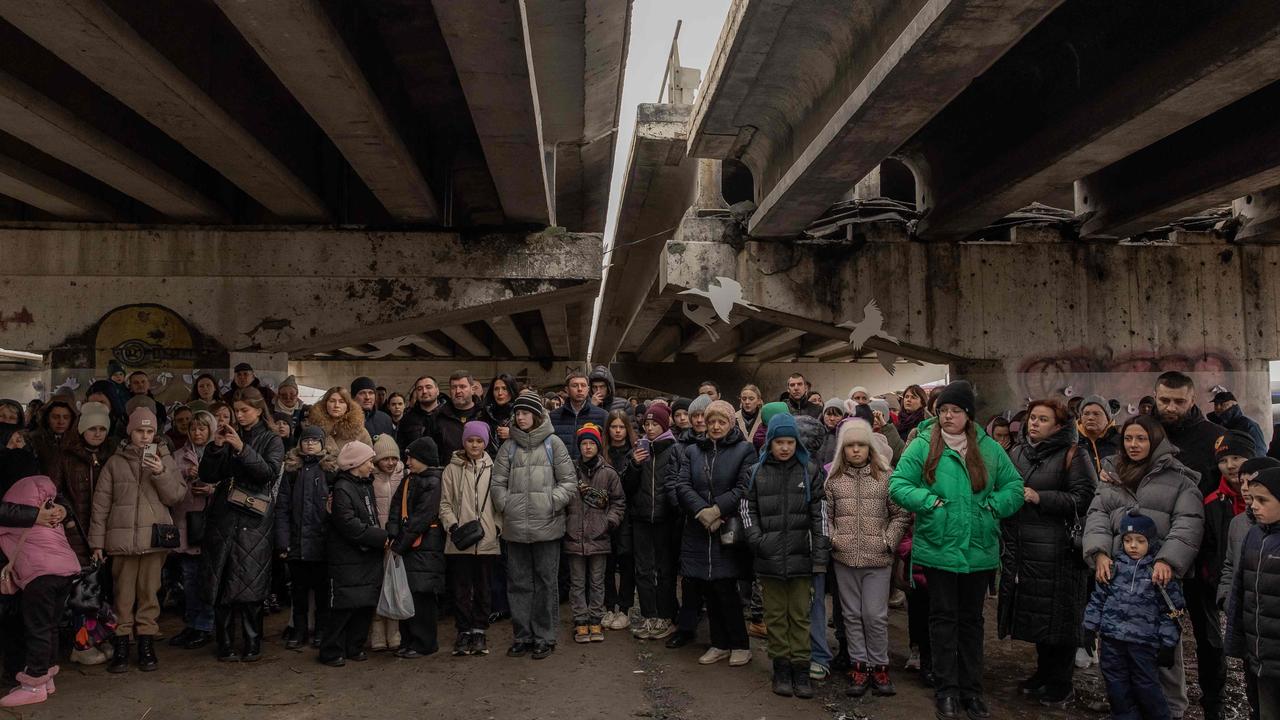 Local residents attend a memorial ceremony under a destroyed bridge in Irpin, northwest of Kyiv on the second anniversary of Russia's invasion of Ukraine. Picture: AFP