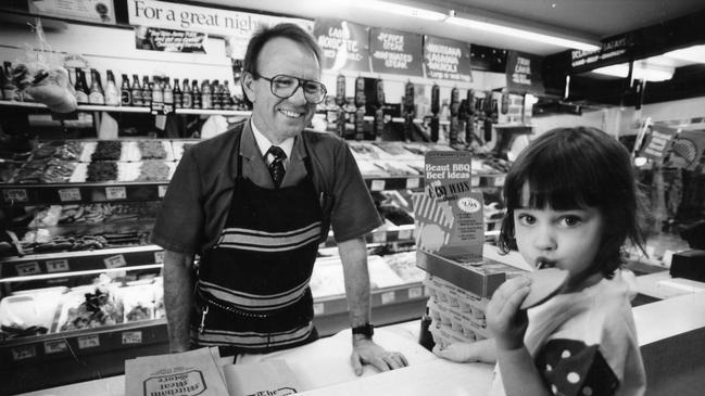 SA butcher Dennis Wilks gives a piece of fritz to Kate Guy, 3, at the Mitcham Meat Store in 1994.