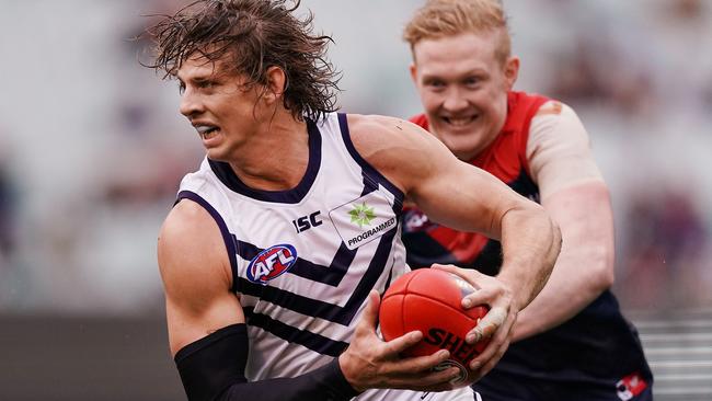 MELBOURNE, AUSTRALIA - JUNE 22: Nat Fyfe of the Dockers runs with the ball from Clayton Oliver of the Demons during the round 14 AFL match between the Melbourne Demons and the Fremantle Dockers at Melbourne Cricket Ground on June 22, 2019 in Melbourne, Australia. (Photo by Michael Dodge/Getty Images)