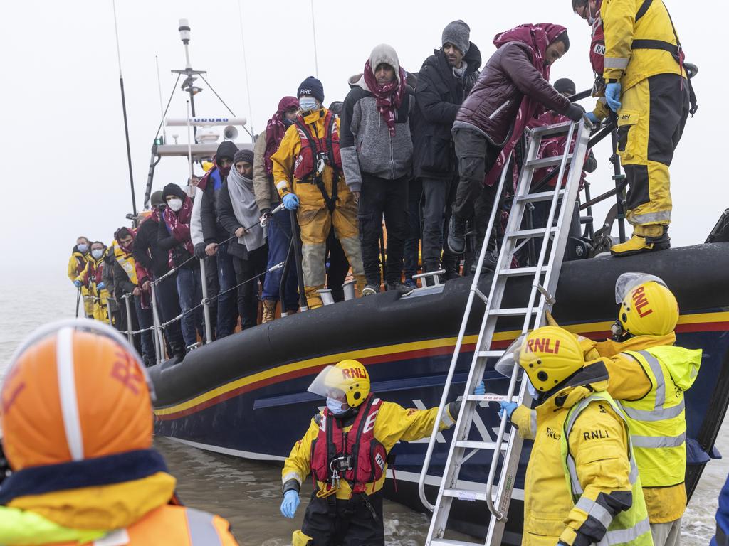 Migrant men are aided ashore in Dungeness, England. Picture: Dan Kitwood/Getty Images