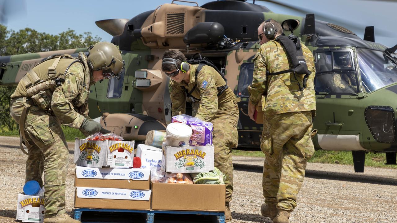 Australian Army soldiers load crates of fresh food onto an MRH-90 Taipan Multi Role Helicopter, ready for delivery to areas of Northern NSW affected by Floods. Picture: CPL Dustin Anderson/Australian Army