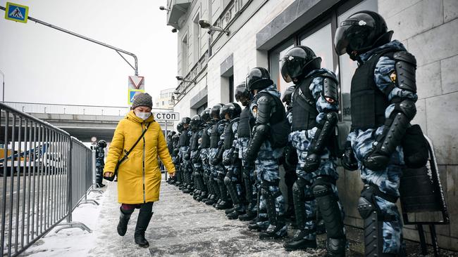 A woman walks in front of riot police during a rally in support of jailed opposition leader Alexei Navalny in 2021. Picture: AFP