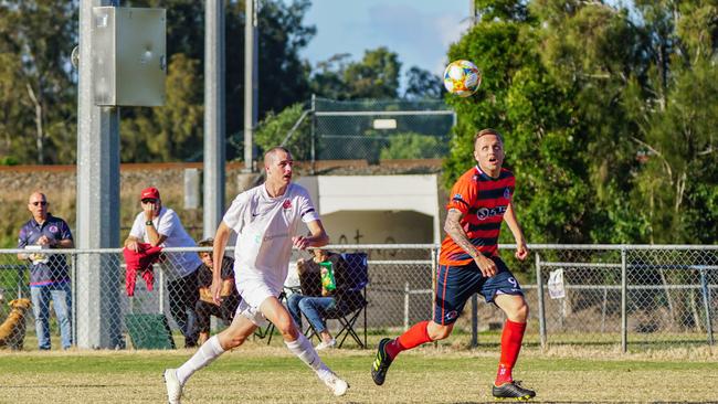 Nerang Eagles playmaker Shaun Robinson strides ahead of his Burleigh opponent during his team thumping four goal haul against reigning Football Gold Copast Premier League titans Burleigh Bulldogs on Sunday. Photo: Luke Sorensen.