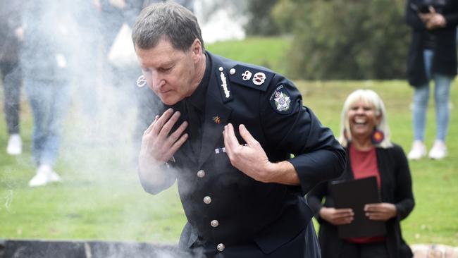 Victoria Police Chief Commissioner Shane Patton participates in a smoking ceremony at the Aborigines Advancement League at Thornbury before delivering an apology to the Stolen Generations. Picture: Andrew Henshaw