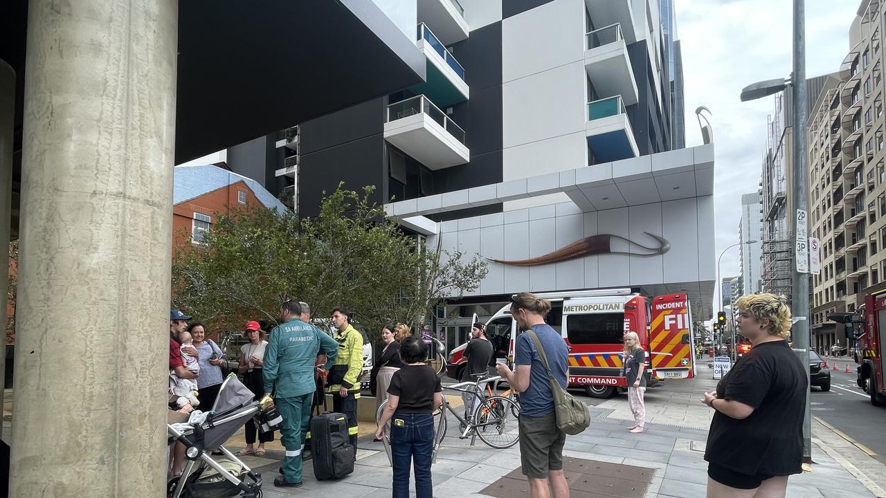 Evacuated residents wait outside the Waymouth St building. Picture: Dylan Hogarth