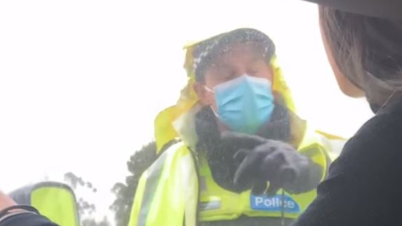 The policeman waves Eve Black through the checkpoint crossing in Melbourne. Picture: Facebook