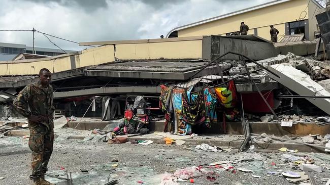 December 17, 2024: A member of security inspecting a collapsed building in Vanuatu's capital Port Vila after a powerful earthquake hit the Pacific island. The 7.3-magnitude quake struck on December 17 at a depth of 57 kilometres (35 miles), some 30 kilometres off the coast of Efate, Vanuatu's main island, at 12:47 pm (0147 GMT), according to the US Geological Survey. (Photo by MICHAEL THOMPSON / Facebook account of Michael Thompson / AFP)