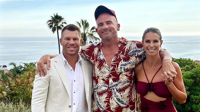 Groom Dominic Purcell (centre) with wedding guests David and Candice Warner.