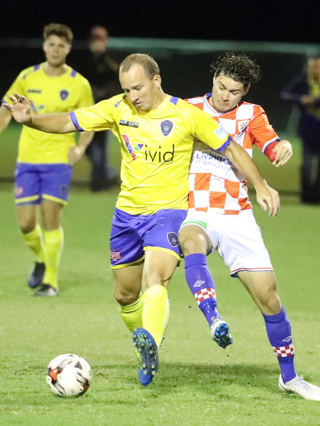 Broadbeach’s Russell Miner battles for possession with Knights’ Roman Hoffman. Picture: Richard Gosling