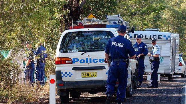 3/6/03 Police at the scene where a body was found off the old Pacific Highway north of Mooney Mooney Picture: MARK SCOTT