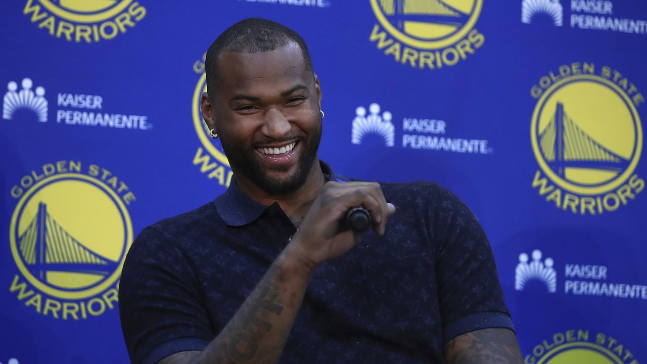 Golden State Warriors' DeMarcus Cousins laughs during a media conference.