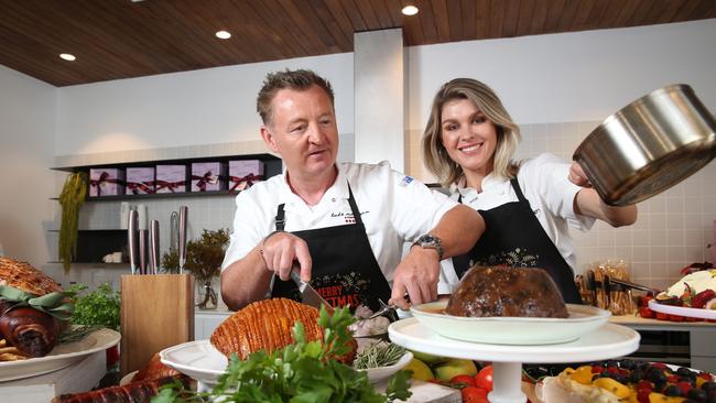 Coles ambassador and TV cook Courtney Roulston and chef Luke Mangan get to work with the Coles Christmas food collection and new MasterChef Knives. Picture: Britta Campion