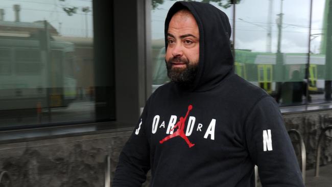 Nabil Maghnie leaves Melbourne West police station this morning. Picture: Andrew Henshaw