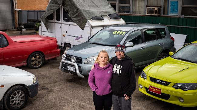 Travis Gregory-Phillipps and Amy Cracknell with dog Ruby are living in a car yard at the former Darlington police station. Picture: Tom Huntley