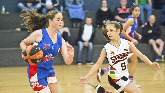 Kianah Lynch from Toowoomba and Naoise Hoet compete in the Basketball Queensland Junior Basketball Competition.