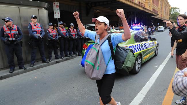 This protester repeatedly screamed, “You are a disgrace to humanity” at police officers as they attempted to clear the roadway. Picture: Alex Coppel.