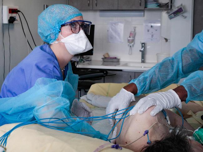 Nursing assistants tend to a patient infected with coronavirus in France as Europe scrambles to contain a surge of the Omicron variant. Picture: AFP