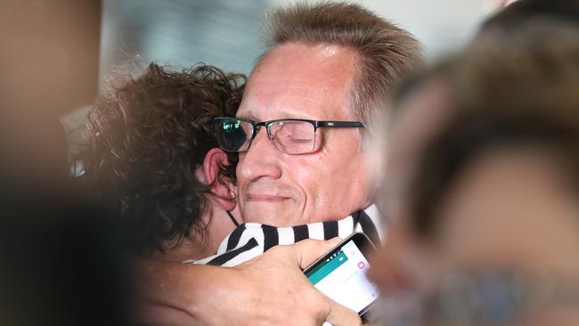 Family members re-unite in Brisbane airport. Picture: Jono Searle