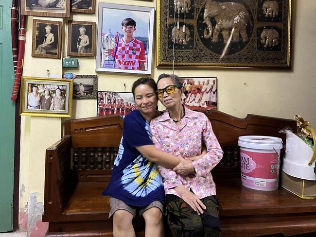 Noy sits beneath a photo of Dom in the family's shophouse in Mae Sai, northern Thailand, with her mother Soy Promthep. Picture: Amanda Hodge